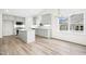 Modern kitchen with white cabinets, a kitchen island, and wood-look flooring at 235 Eason Creek Way, Clayton, NC 27527