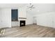 Inviting living area showcasing a fireplace with wood trim, and wood look flooring at 235 Eason Creek Way, Clayton, NC 27527