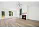Cozy living room features a fireplace, a ceiling fan and wood-look flooring at 235 Eason Creek Way, Clayton, NC 27527