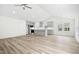 Bright open-concept living space showcasing hardwood floors and gray kitchen island at 235 Eason Creek Way, Clayton, NC 27527