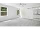 Spacious primary bedroom featuring two windows and a sliding barn door to the ensuite at 235 Eason Creek Way, Clayton, NC 27527