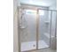 Modern shower with glass enclosure, built-in seat, and marble-patterned tiling at 235 Eason Creek Way, Clayton, NC 27527
