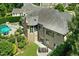 Aerial view of home with a patio, pool, lush landscaping and mature trees at 238 Michelangelo Way, Cary, NC 27518
