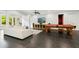 Basement living room showcases pool table, modern media center, white sofas, and black tile floors at 238 Michelangelo Way, Cary, NC 27518