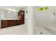 Tiled bathroom featuring a glass shower and dark wood cabinets at 238 Michelangelo Way, Cary, NC 27518