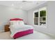 Bedroom features white walls, pink bed frame, white comforter, and a view of outside at 238 Michelangelo Way, Cary, NC 27518