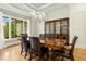 Dining room features hardwood floors, large window, chandelier, and a beautiful china cabinet at 238 Michelangelo Way, Cary, NC 27518