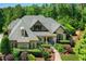 Beautiful home with a brick and stone facade, professional landscaping and a charming covered porch at 238 Michelangelo Way, Cary, NC 27518