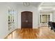 Entryway featuring hardwood floors, arched double doors, and elegant lighting fixture at 238 Michelangelo Way, Cary, NC 27518