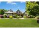 Charming home featuring lush lawn, colorful landscaping and a brick and stone facade at 238 Michelangelo Way, Cary, NC 27518