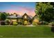 Beautiful brick home featuring a manicured lawn, professional landscaping, and inviting front porch at 238 Michelangelo Way, Cary, NC 27518