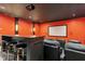 Home theater room with projector and screen, black leather seating, bar seating and red walls at 238 Michelangelo Way, Cary, NC 27518