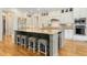 Elegant kitchen with an oversized island, seating, stainless steel appliances, and custom white cabinetry at 238 Michelangelo Way, Cary, NC 27518