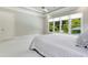 Light-filled main bedroom featuring large windows, neutral tones, and a ceiling fan at 238 Michelangelo Way, Cary, NC 27518