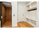 This mudroom includes a wood elevator, built in storage and bench with coat hooks, and beautiful wood floors at 238 Michelangelo Way, Cary, NC 27518