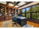 This traditional office includes beautiful wood built-ins, a large desk and chair, and several large windows at 238 Michelangelo Way, Cary, NC 27518