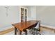 This modern home office includes a wood desk and rolling chair, along with minimalist decor and an area rug at 238 Michelangelo Way, Cary, NC 27518