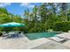 Inviting outdoor pool area with sun loungers and a table with umbrella, perfect for relaxation at 238 Michelangelo Way, Cary, NC 27518