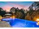 Inviting outdoor pool at sunset with umbrella covered table and a fire pit feature at 238 Michelangelo Way, Cary, NC 27518