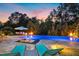 Inviting pool area with in-pool loungers, a dining set and beautiful outdoor lighting for evening enjoyment at 238 Michelangelo Way, Cary, NC 27518