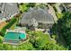 A stunning aerial view showcases the beautiful brick home, pool, patio, and lush landscaping at 238 Michelangelo Way, Cary, NC 27518