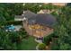 The brick home's backyard is shown in this aerial view, featuring a patio, lush landscaping, and privacy at 238 Michelangelo Way, Cary, NC 27518