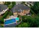 This aerial view showcases the brick home's outdoor patio, pool, and lush landscaping at 238 Michelangelo Way, Cary, NC 27518