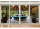 This sunroom is fully furnished with a unique semi circle shaped couch, stone fireplace, and lots of plants at 238 Michelangelo Way, Cary, NC 27518