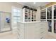 Well-organized walk-in closet with custom cabinets and central island with drawers at 238 Michelangelo Way, Cary, NC 27518