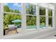 Views of a pool, patio, and outdoor kitchen, as seen through a wall of windows at 238 Michelangelo Way, Cary, NC 27518