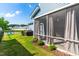 Backyard featuring a screened porch, grassy area, and black metal fence at 279 Edge Of Auburn Blvd, Raleigh, NC 27610