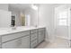 Bright bathroom featuring a double sink vanity with modern fixtures and a large mirror at 279 Edge Of Auburn Blvd, Raleigh, NC 27610