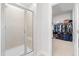 An open-concept bathroom showing a tiled shower and walk-in closet with custom shelving at 279 Edge Of Auburn Blvd, Raleigh, NC 27610