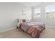 Bedroom featuring a queen bed, two windows, and a decorative 'Mr. and Mrs.' pillow at 279 Edge Of Auburn Blvd, Raleigh, NC 27610