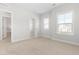A bright bedroom with neutral walls, carpet and windows, alongside an open closet at 279 Edge Of Auburn Blvd, Raleigh, NC 27610