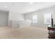 Upstairs bonus room with neutral carpet, windows for natural light, and a TV ready for entertainment at 279 Edge Of Auburn Blvd, Raleigh, NC 27610