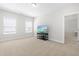 Upstairs bonus room with neutral carpet, windows for natural light, and TV stand at 279 Edge Of Auburn Blvd, Raleigh, NC 27610