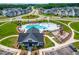 Aerial shot of a community clubhouse with a pool and playground in a well-maintained neighborhood at 279 Edge Of Auburn Blvd, Raleigh, NC 27610