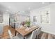 Open dining area features wood floors, gray chairs, with sight lines into the kitchen and living spaces at 279 Edge Of Auburn Blvd, Raleigh, NC 27610
