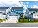 A charming blue home with a garage and a well-kept lawn with a black iron fence at 279 Edge Of Auburn Blvd, Raleigh, NC 27610