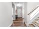 Bright hallway with wood flooring, leading to the front door and staircase to the upper level at 279 Edge Of Auburn Blvd, Raleigh, NC 27610