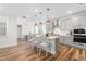 Open kitchen with a large island, barstool seating, and modern pendant lighting at 279 Edge Of Auburn Blvd, Raleigh, NC 27610