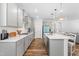 Modern kitchen with gray cabinets, subway tile backsplash, and a spacious center island at 279 Edge Of Auburn Blvd, Raleigh, NC 27610
