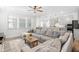Bright and airy living room with a large sectional sofa, view into the kitchen and lots of natural light at 279 Edge Of Auburn Blvd, Raleigh, NC 27610