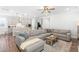 Spacious living room with an open concept, including a large sectional sofa and a view of the kitchen at 279 Edge Of Auburn Blvd, Raleigh, NC 27610