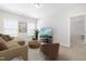 Bright living room features neutral tones, large windows, and comfortable seating at 279 Edge Of Auburn Blvd, Raleigh, NC 27610
