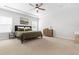 Spacious bedroom with tray ceiling, ceiling fan, and ample natural light from two windows at 279 Edge Of Auburn Blvd, Raleigh, NC 27610