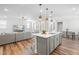 Open-concept living room and kitchen with a large kitchen island and comfortable seating at 279 Edge Of Auburn Blvd, Raleigh, NC 27610