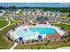 Aerial view of the neighborhood pool with lounge chairs, a splash pad, and a playground nearby at 279 Edge Of Auburn Blvd, Raleigh, NC 27610