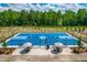 Brand-new, fenced in sport court features shade umbrellas and picnic benches for socializing at 279 Edge Of Auburn Blvd, Raleigh, NC 27610
